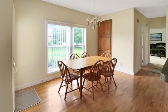 1503 Nottingham Dr, Warrensburg, MO 64093 - dining area featuring a chandelier and light wood-style floors