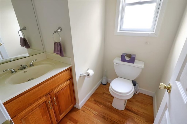 1503 Nottingham Dr, Warrensburg, MO 64093 - half bathroom featuring vanity and wood finished floors