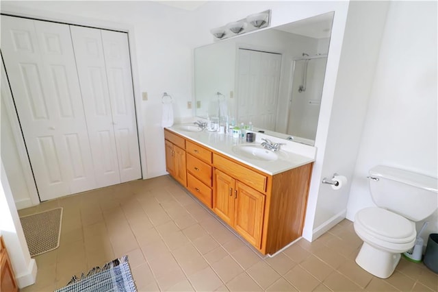 1503 Nottingham Dr, Warrensburg, MO 64093 - bathroom featuring double vanity, a closet, tile patterned flooring, and a shower with shower door