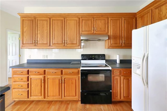 1503 Nottingham Dr, Warrensburg, MO 64093 - kitchen with white refrigerator with ice dispenser, electric range oven, ventilation hood, dark countertops, and light wood finished floors