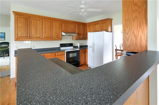 1503 Nottingham Dr, Warrensburg, MO 64093 - kitchen with range with electric stovetop, white refrigerator with ice dispenser, under cabinet range hood, a ceiling fan, and light wood-style floors