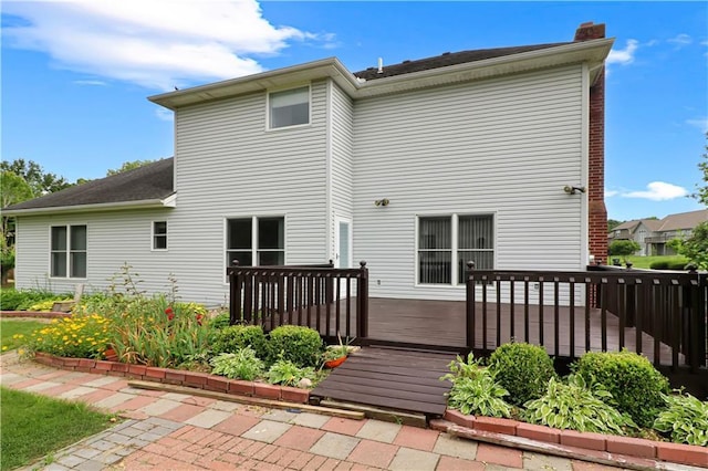 1503 Nottingham Dr, Warrensburg, MO 64093 - rear view of house featuring a wooden deck and a chimney