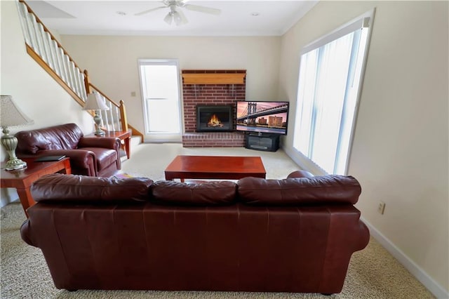 1503 Nottingham Dr, Warrensburg, MO 64093 - living room with carpet flooring, stairs, ceiling fan, a fireplace, and crown molding