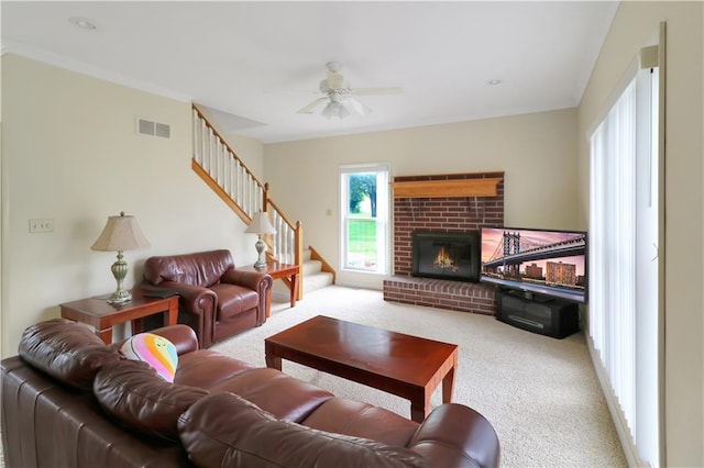 1503 Nottingham Dr, Warrensburg, MO 64093 - living area featuring stairway, carpet floors, a brick fireplace, and ceiling fan