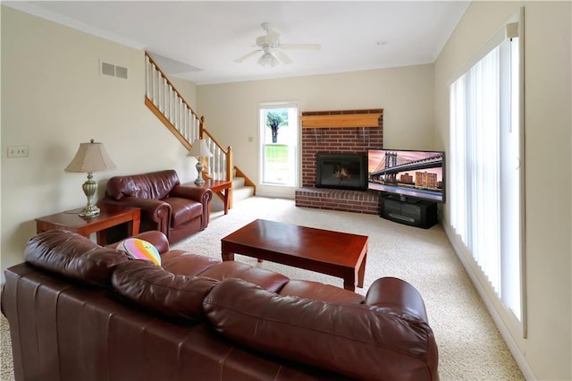 1503 Nottingham Dr, Warrensburg, MO 64093 - living room featuring carpet floors, stairs, a ceiling fan, a brick fireplace, and ornamental molding