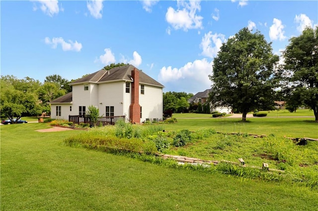 1503 Nottingham Dr, Warrensburg, MO 64093 - view of property exterior with a wooden deck and a yard