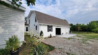 4901 E 215th St, Belton, MO 64012 - back of house with an outbuilding and a patio