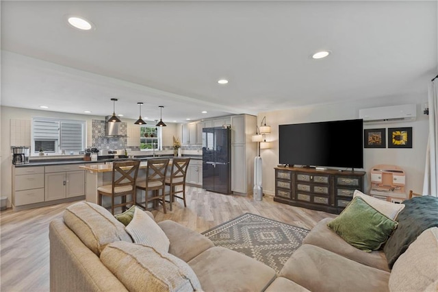 4901 E 215th St, Belton, MO 64012 - living room with an AC wall unit, recessed lighting, and light wood finished floors