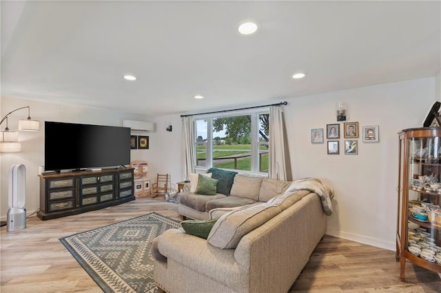4901 E 215th St, Belton, MO 64012 - living room featuring a wall unit AC, recessed lighting, and light wood-style floors