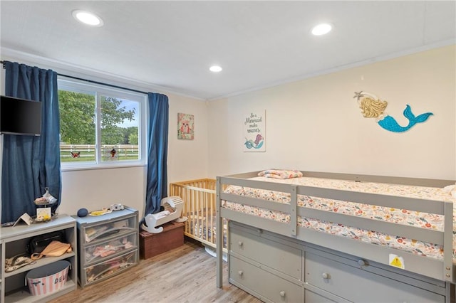 4901 E 215th St, Belton, MO 64012 - bedroom featuring light wood-type flooring, recessed lighting, crown molding, and a nursery area