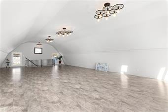 4901 E 215th St, Belton, MO 64012 - additional living space featuring a chandelier and vaulted ceiling