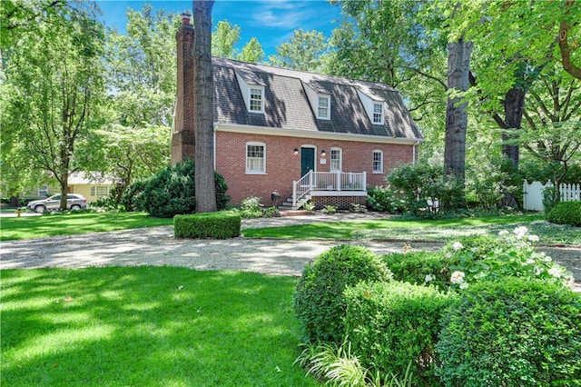 4912 W 69th St, Prairie Village, KS 66208 - view of front of property with a chimney, brick siding, and a front yard