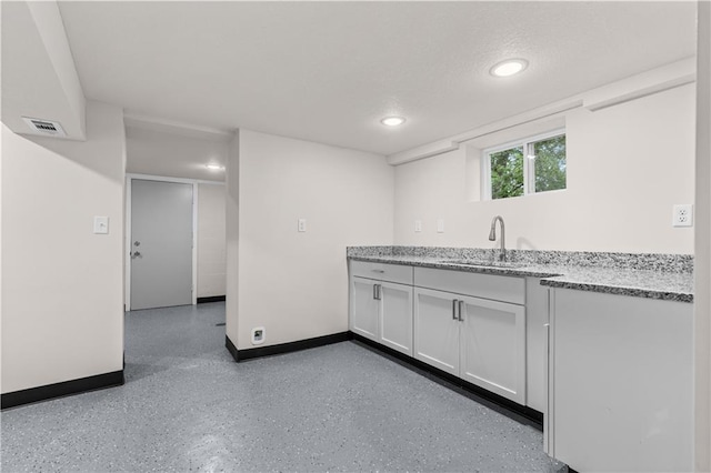 3107 N 34th St, Kansas City, KS 66104 - kitchen with recessed lighting, white cabinets, and light stone counters