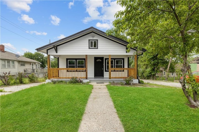 3107 N 34th St, Kansas City, KS 66104 - bungalow-style house featuring a front yard and covered porch