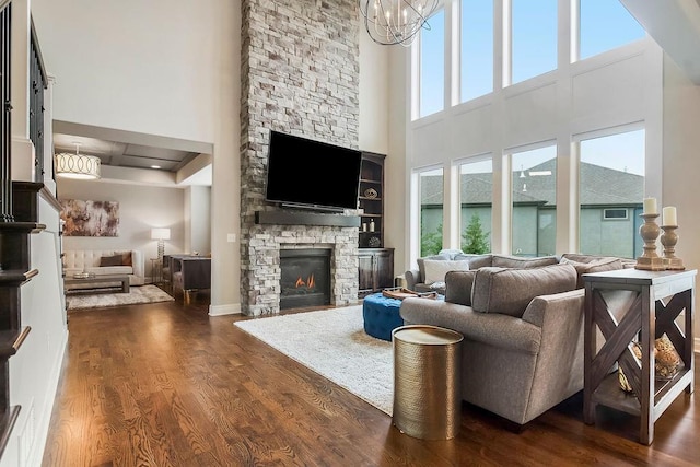 15801 Canterbury St, Overland Park, KS 66224 - living area featuring a towering ceiling, a fireplace, dark wood-type flooring, and a chandelier