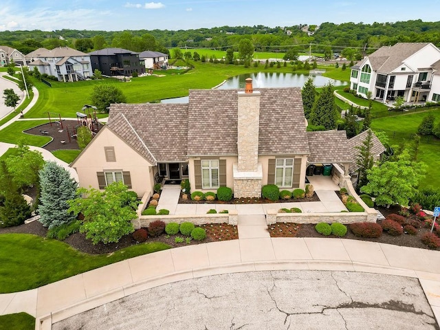 15801 Canterbury St, Overland Park, KS 66224 - view of front facade featuring stucco siding, a chimney, a water view, a residential view, and stone siding