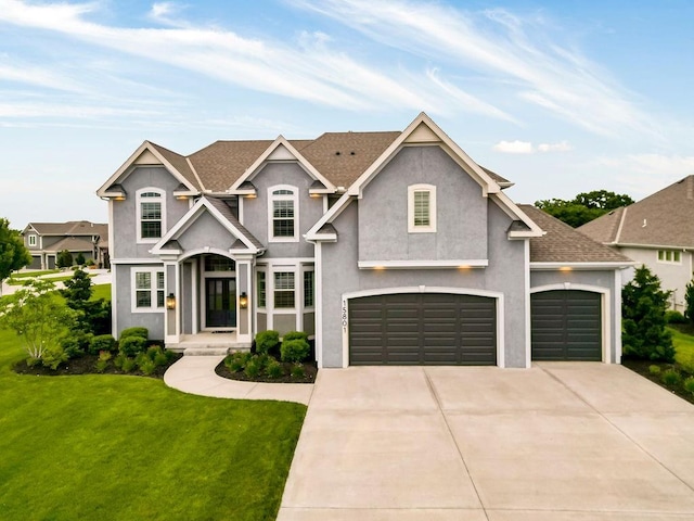 15801 Canterbury St, Overland Park, KS 66224 - view of front of home featuring a front lawn, stucco siding, driveway, and an attached garage