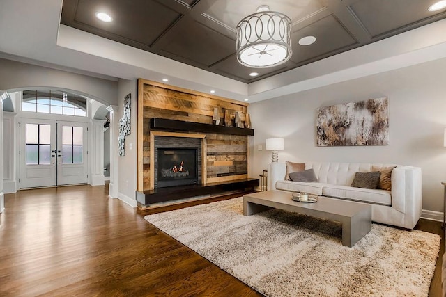 15801 Canterbury St, Overland Park, KS 66224 - living room with arched walkways, dark wood-type flooring, french doors, recessed lighting, and a fireplace