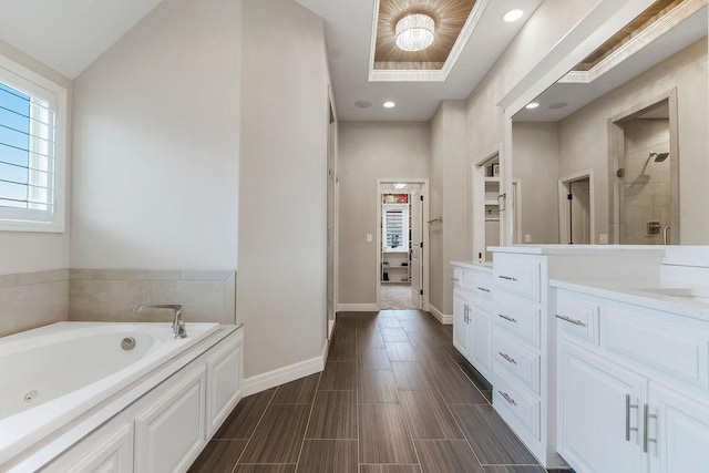 15801 Canterbury St, Overland Park, KS 66224 - bathroom featuring vanity, a jetted tub, a shower stall, recessed lighting, and wood finished floors