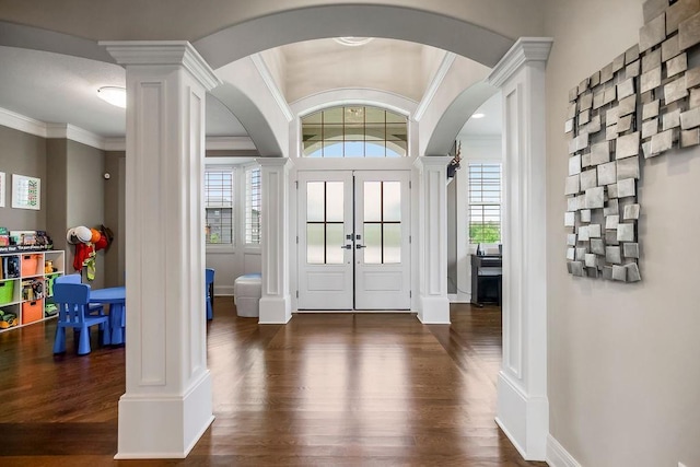 15801 Canterbury St, Overland Park, KS 66224 - foyer entrance with ornate columns, arched walkways, dark wood-style floors, plenty of natural light, and ornamental molding