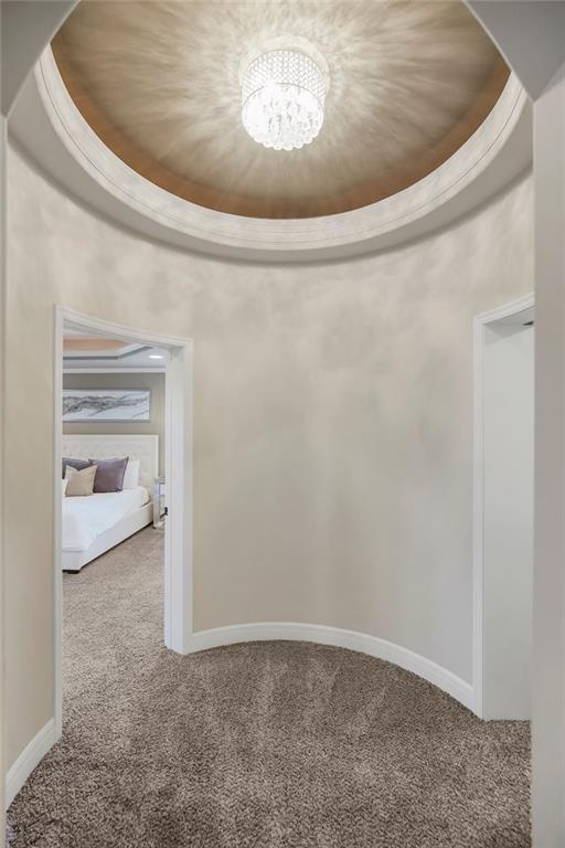 15801 Canterbury St, Overland Park, KS 66224 - hallway with carpet and a chandelier