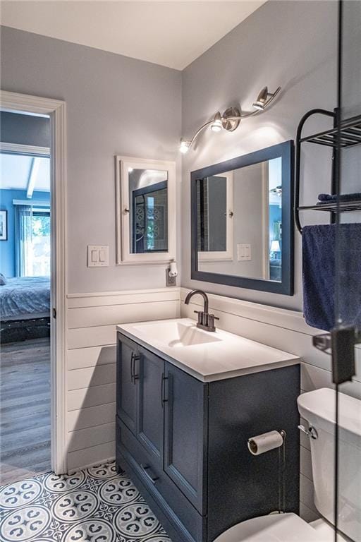 8605 Deer Run St, Lenexa, KS 66220 - ensuite bathroom featuring vanity and a wainscoted wall