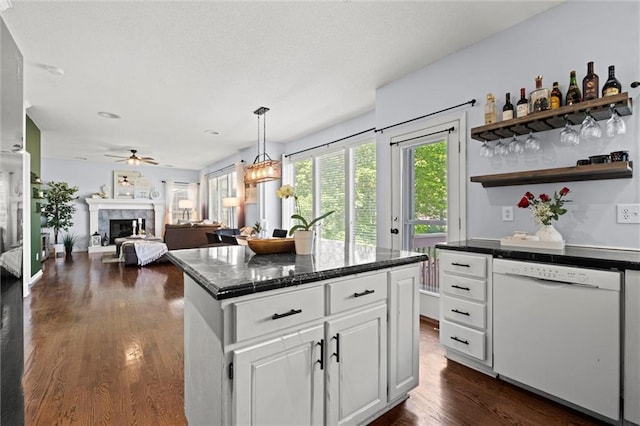 22116 W 51st St, Shawnee, KS 66226 - kitchen featuring white dishwasher, dark wood-style floors, ceiling fan, white cabinetry, and a fireplace