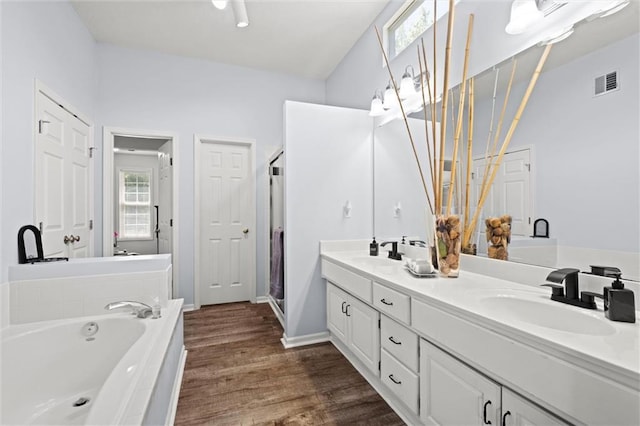 22116 W 51st St, Shawnee, KS 66226 - full bathroom featuring double vanity, a bath, wood finished floors, and a shower stall
