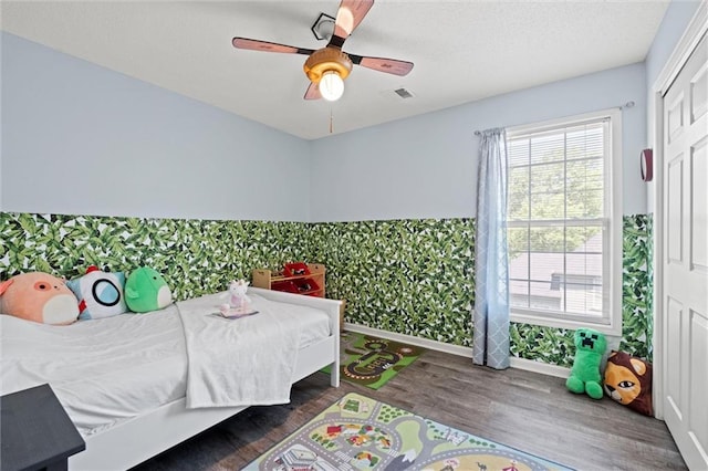 22116 W 51st St, Shawnee, KS 66226 - bedroom with wood finished floors, wallpapered walls, ceiling fan, and a closet