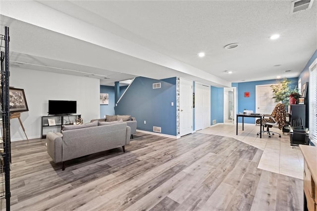 22116 W 51st St, Shawnee, KS 66226 - living area featuring light wood-type flooring, recessed lighting, and a textured ceiling