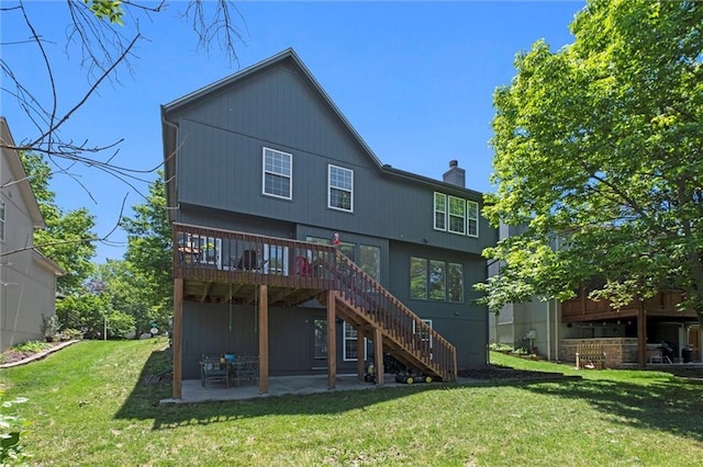22116 W 51st St, Shawnee, KS 66226 - rear view of house featuring stairs, a patio, a yard, a deck, and a chimney