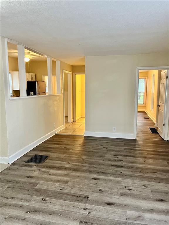 551 S Brookside Ave, Independence, MO 64053 - unfurnished living room with wood finished floors