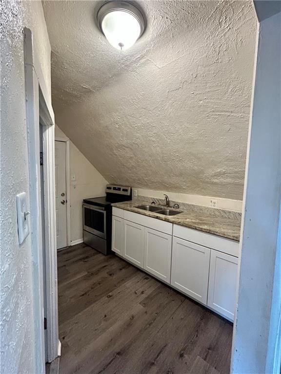551 S Brookside Ave, Independence, MO 64053 - kitchen with electric stove, dark wood finished floors, a textured ceiling, white cabinets, and lofted ceiling