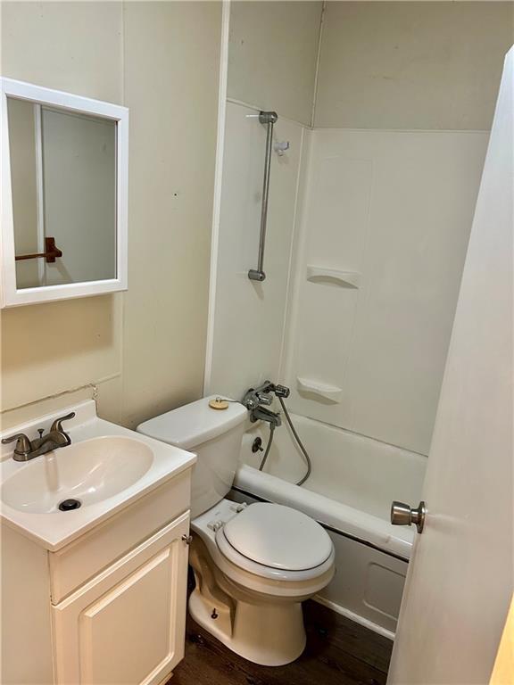 551 S Brookside Ave, Independence, MO 64053 - bathroom featuring vanity, shower / bath combo, and wood finished floors