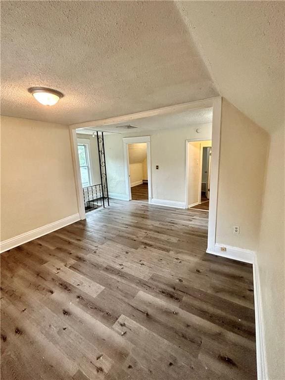 551 S Brookside Ave, Independence, MO 64053 - spare room featuring a textured ceiling and wood finished floors