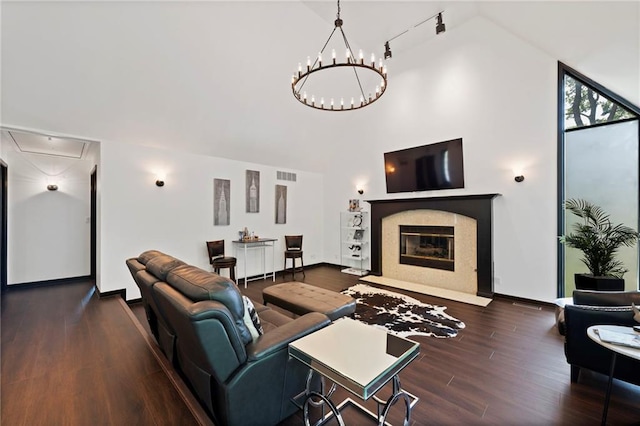 4813 NW Northwood Rd, Riverside, MO 64150 - living area with attic access, wood finished floors, a fireplace, high vaulted ceiling, and a chandelier