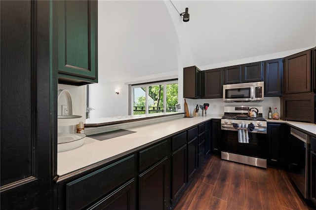4813 NW Northwood Rd, Riverside, MO 64150 - kitchen with stainless steel appliances, a towering ceiling, light countertops, and dark wood-style floors
