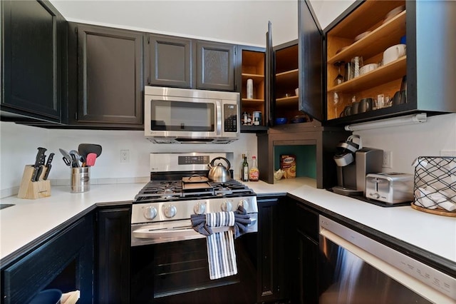 4813 NW Northwood Rd, Riverside, MO 64150 - kitchen with stainless steel appliances, light countertops, and dark cabinets