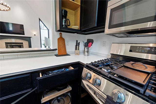 4813 NW Northwood Rd, Riverside, MO 64150 - kitchen featuring appliances with stainless steel finishes, light countertops, and dark cabinetry