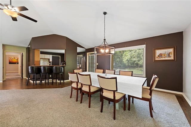 4813 NW Northwood Rd, Riverside, MO 64150 - dining room with lofted ceiling, a chandelier, wood finished floors, carpet flooring, and a ceiling fan