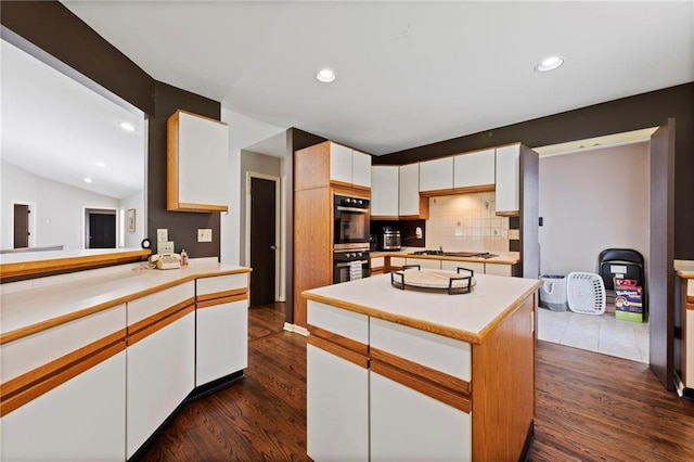 4813 NW Northwood Rd, Riverside, MO 64150 - kitchen featuring double wall oven, light countertops, gas stovetop, white cabinetry, and decorative backsplash