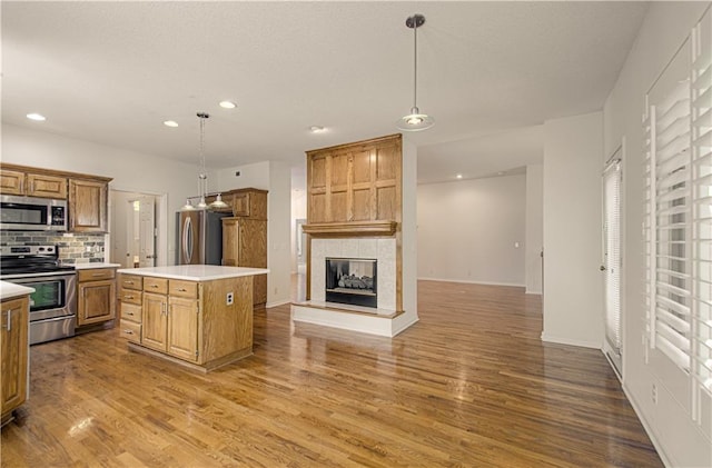 6306 W 128th St, Overland Park, KS 66209 - kitchen featuring appliances with stainless steel finishes, wood finished floors, recessed lighting, and light countertops