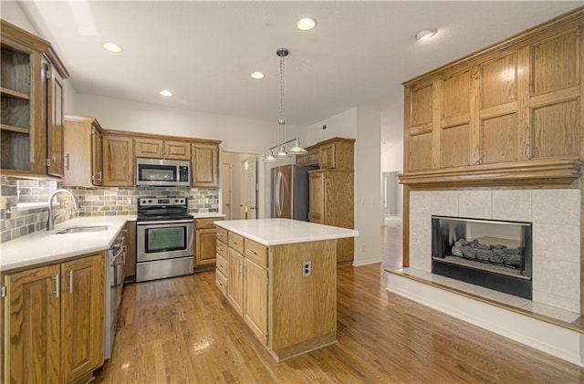 6306 W 128th St, Overland Park, KS 66209 - kitchen featuring stainless steel appliances, a kitchen island, light wood-type flooring, tasteful backsplash, and recessed lighting