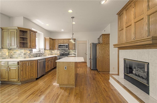 6306 W 128th St, Overland Park, KS 66209 - kitchen with stainless steel appliances, a kitchen island, open shelves, backsplash, and light countertops