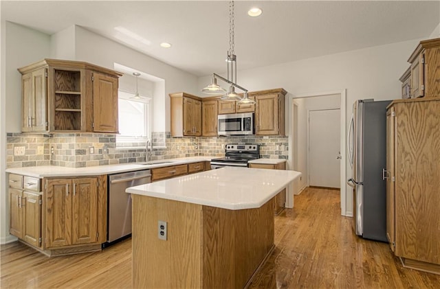 6306 W 128th St, Overland Park, KS 66209 - kitchen featuring appliances with stainless steel finishes, a kitchen island, decorative backsplash, light countertops, and recessed lighting