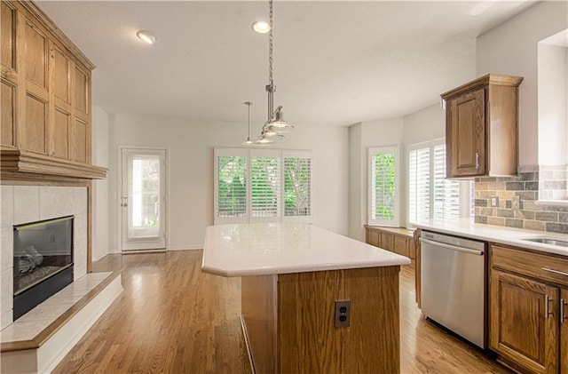 6306 W 128th St, Overland Park, KS 66209 - kitchen featuring dishwasher, a center island, plenty of natural light, brown cabinetry, and recessed lighting