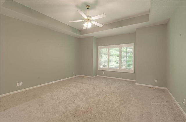 6306 W 128th St, Overland Park, KS 66209 - unfurnished room with a raised ceiling, carpet, and ceiling fan