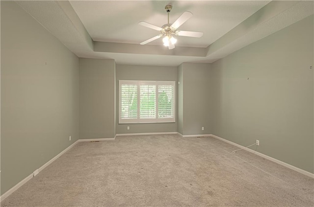 6306 W 128th St, Overland Park, KS 66209 - empty room featuring a tray ceiling, carpet floors, and ceiling fan