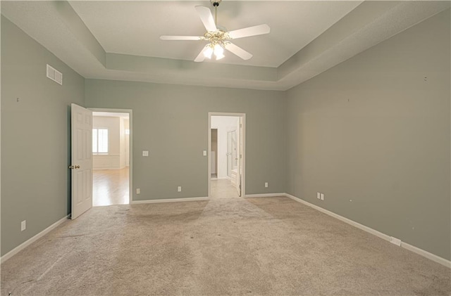 6306 W 128th St, Overland Park, KS 66209 - spare room featuring a raised ceiling, light colored carpet, and a ceiling fan