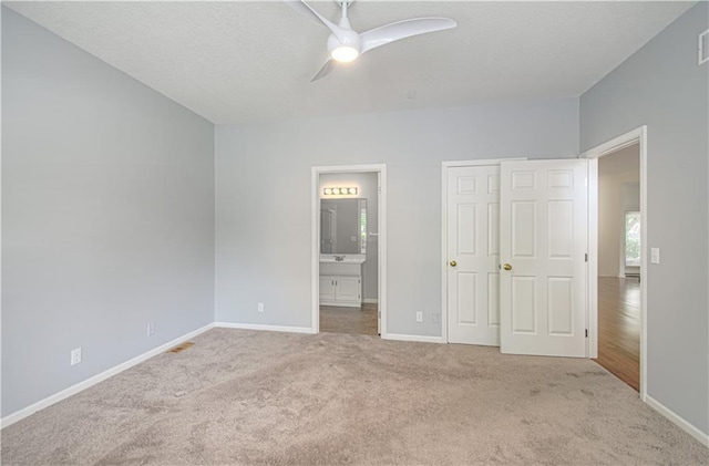 6306 W 128th St, Overland Park, KS 66209 - unfurnished bedroom featuring carpet flooring, connected bathroom, a closet, and ceiling fan